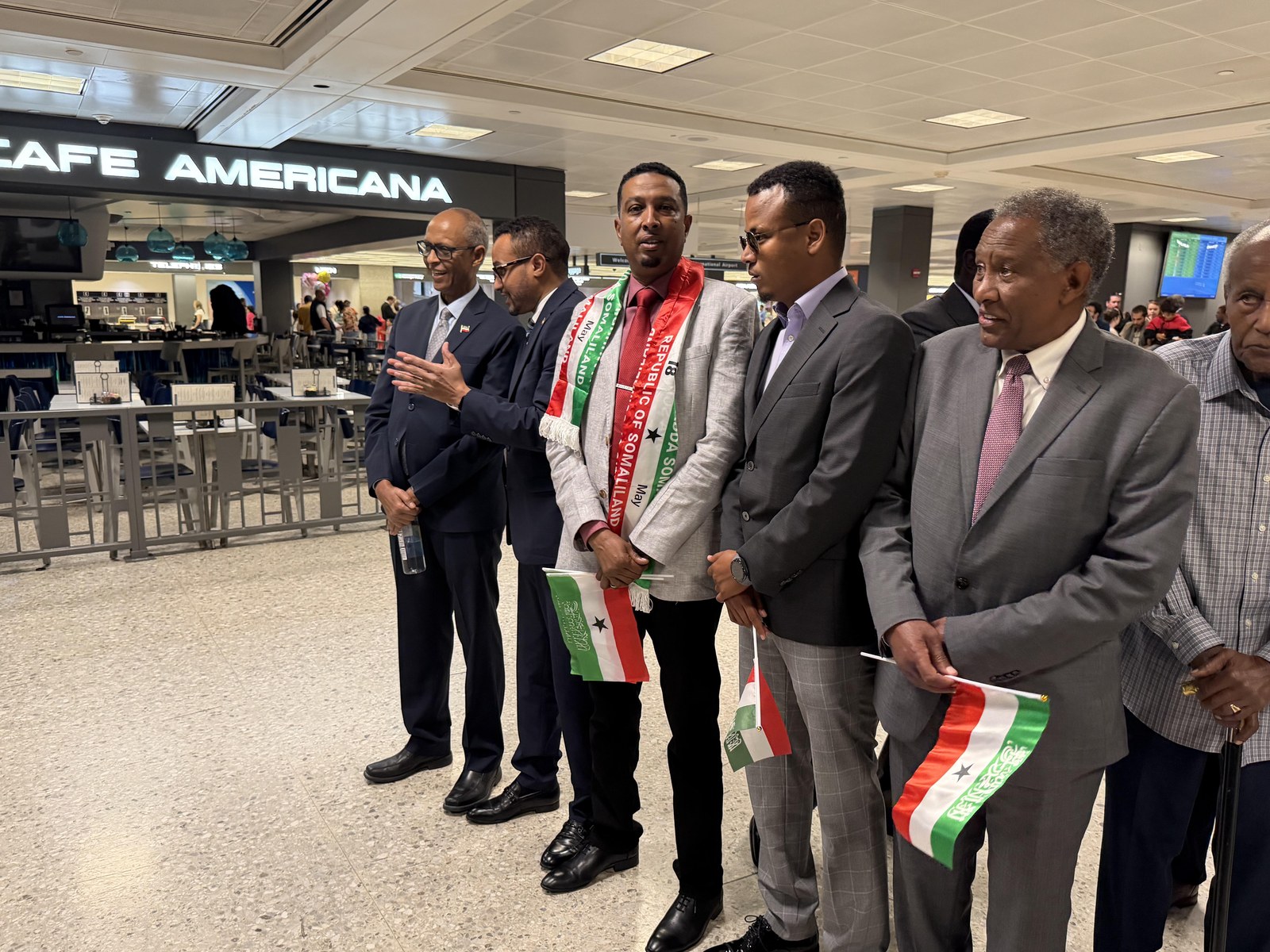 Community members holding Somaliland flags at the airport