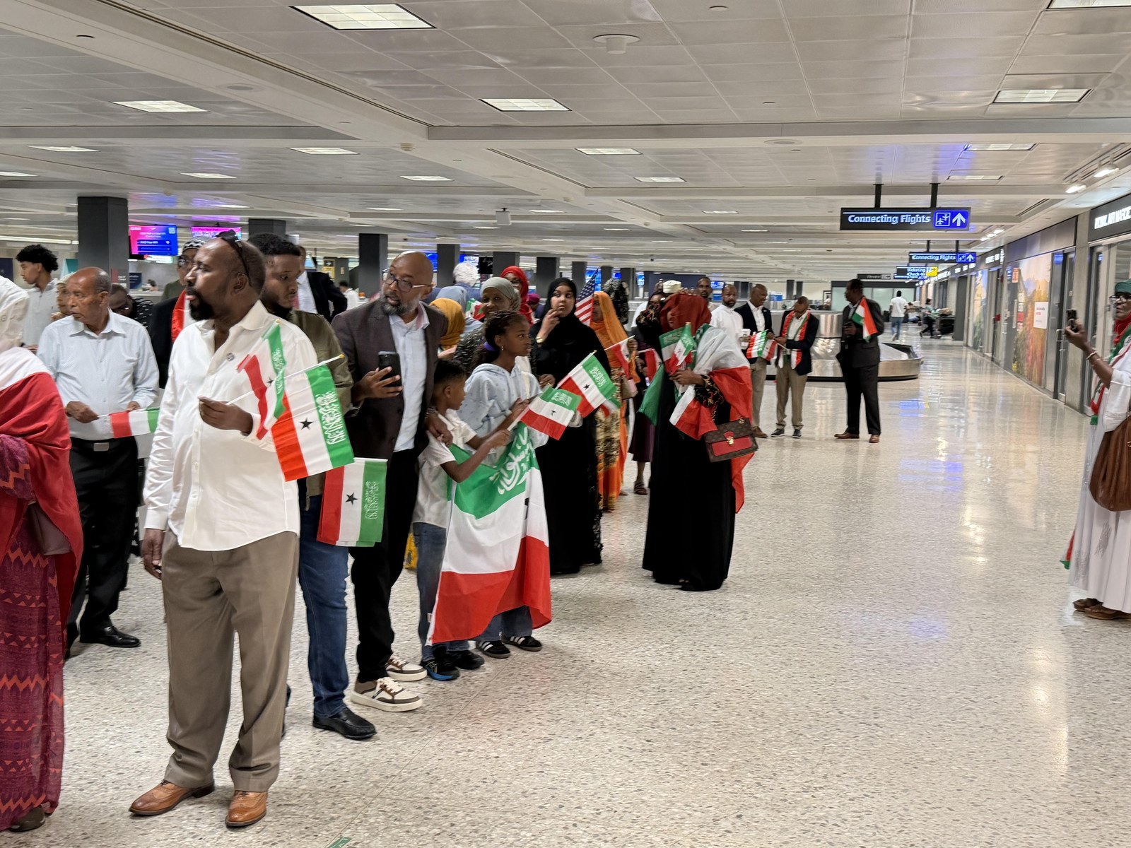 Somaliland and American flags held together at the airport welcome